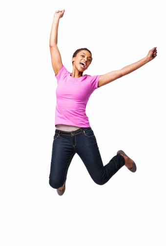 Full length of an ecstatic African American female jumping in excitement. Vertical shot. Isolated on white.