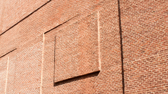 Square relief in brick wall