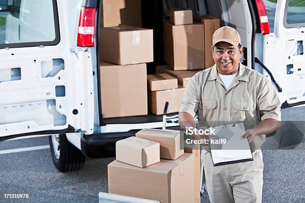 Hispanic Man Delivering Packages Stock Photo - Download Image Now - Hand Truck, 40-44 Years, 40-49 Years