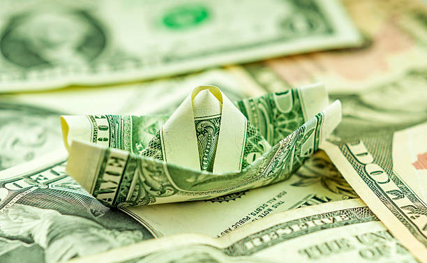 istock Dollar paper boat standing on bills 171315985