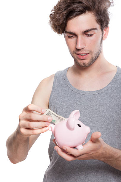 istock Young man with piggy bank 171316524