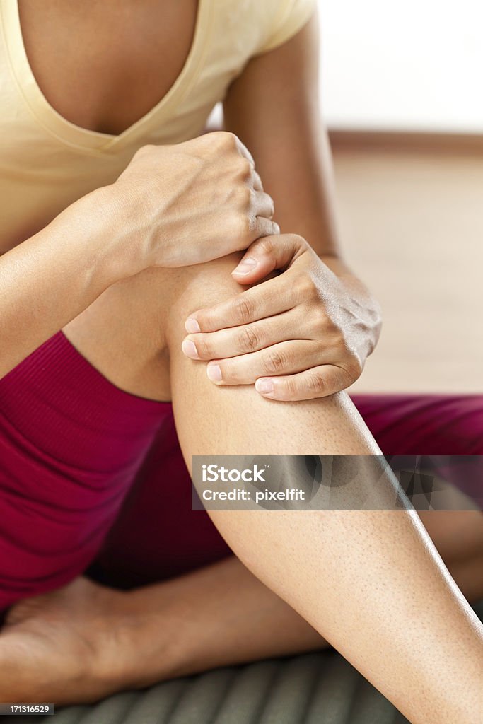 Knee pain Woman feeling pain in the knee Pain Stock Photo