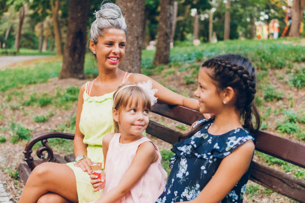 istock A mother enjoys with her daughters in the park 1713165457