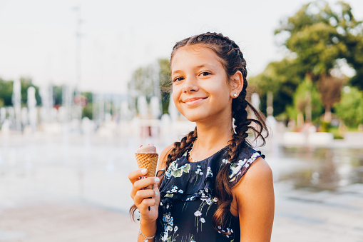 A beautiful little girl eating ice-cream