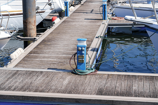 Charging station for boats in the harbor with electrical outlets