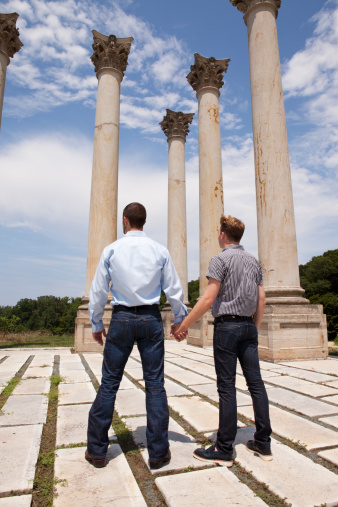 A gay couple holds hands and looks to the horizon awaiting court decisions that will ultimately determine if LGBT people will have the right to marry in the United States. 