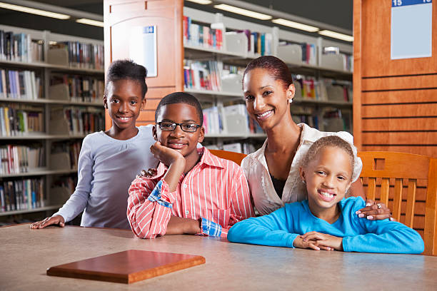 istock Children with teacher in library 171318920