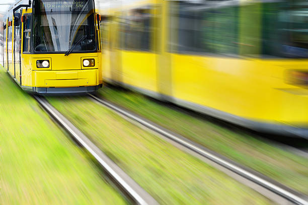 Tram, on grass "Environment friendly tram on grass, motion blurred background" blurred motion street car green stock pictures, royalty-free photos & images
