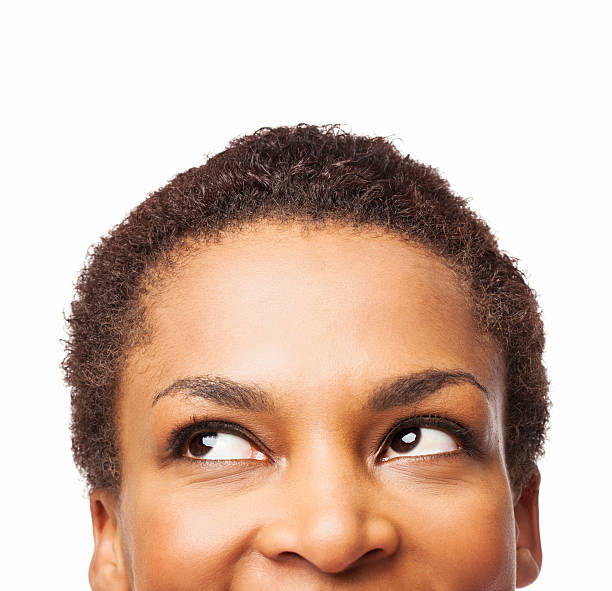 African American Woman Looking Up - Isolated Cropped view of African American woman looking up. Horizontal shot. Isolated on white. sideways glance stock pictures, royalty-free photos & images