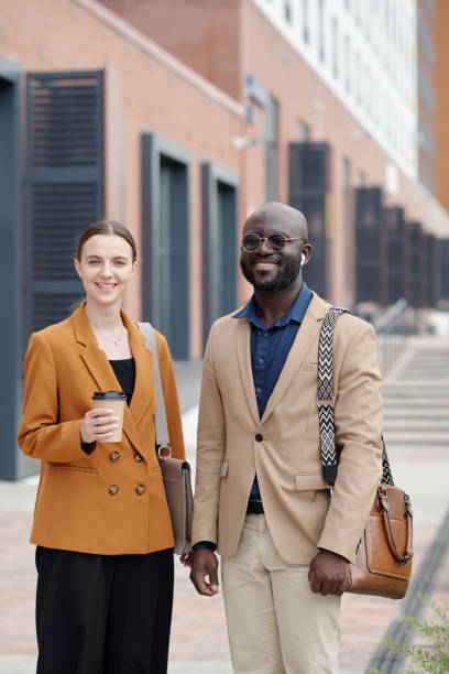 istock Young intercultural white collar workers in formalwear standing outdoors 1713199959