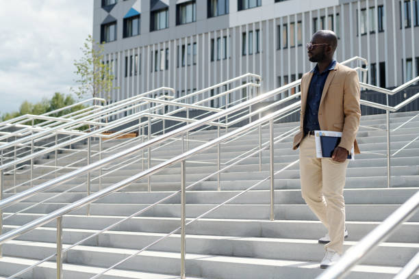 istock Young serious African American male solopreneur with documents and tablet 1713201154