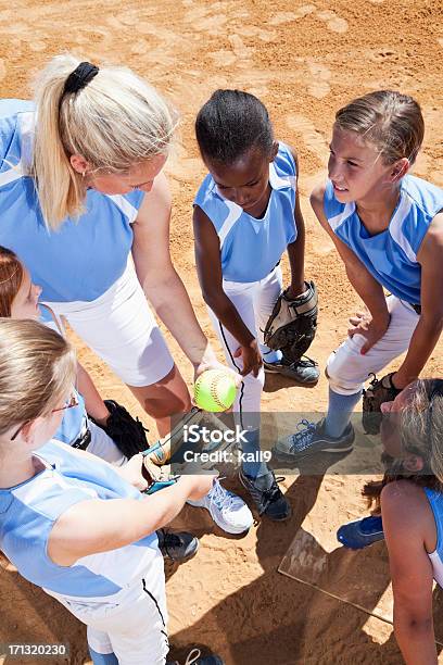 Softball Team With Coach In Huddle Stock Photo - Download Image Now - 10-11 Years, 40-49 Years, 6-7 Years