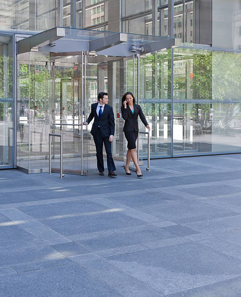 istock Business people exiting through glass doors 171320833
