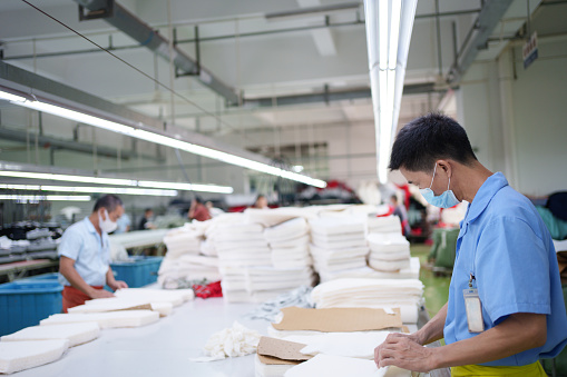 Male worker in garment factory at work