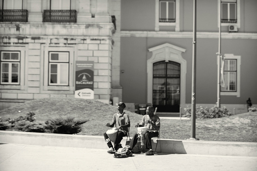 Lisbon, Portugal - July 29, 2023: A duo of street musicians play percussion in Lisbon downotwn.