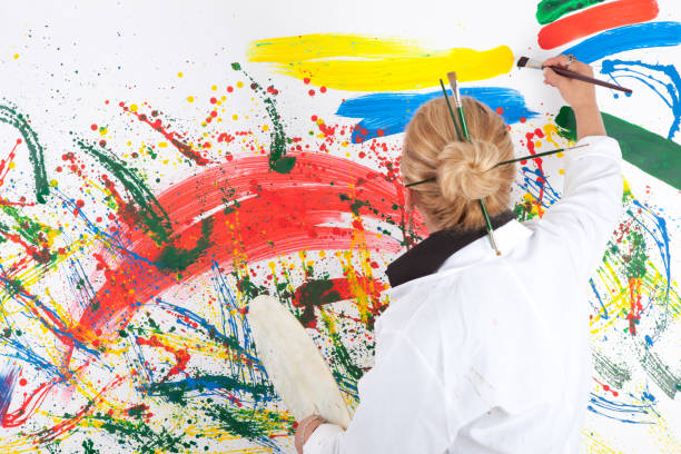 istock Artist woman standing before painting 171321334