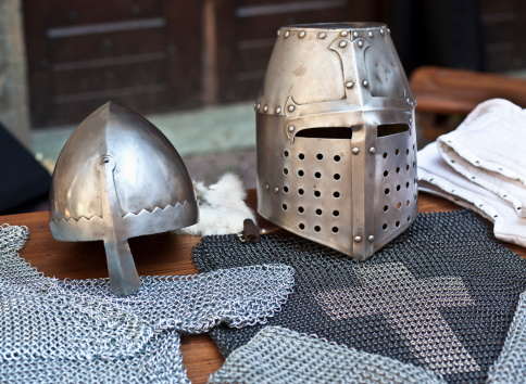 Two different kinds of medieval helmets and iron mail.See also: