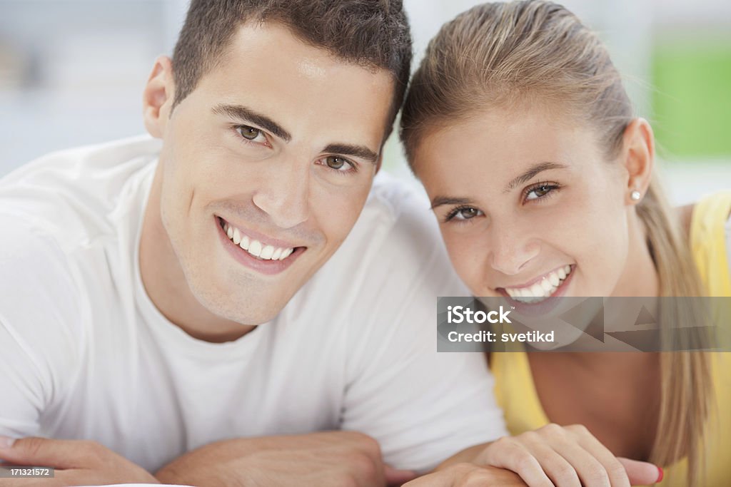 Young couple Close up of happy young couple smiling and looking at camera..See more LIFESTYLE images with this YOUNG COUPLE. Click on image below for lightbox. 20-29 Years Stock Photo