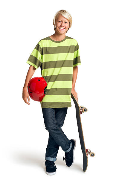 Close-up of a teenage boy carrying skateboard and smiling