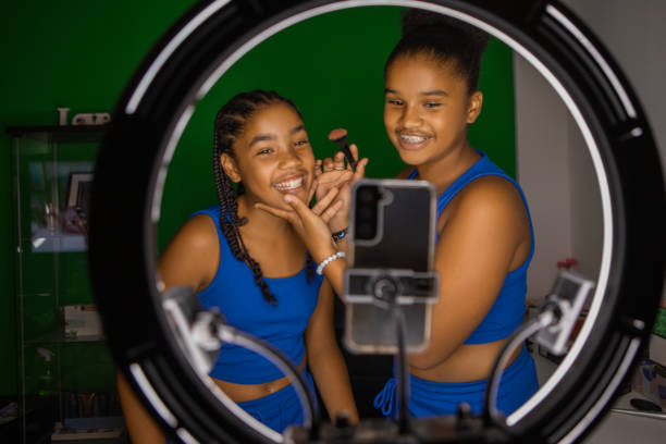 istock Diverse Teen sisters doing make-up classes at home 1713216514