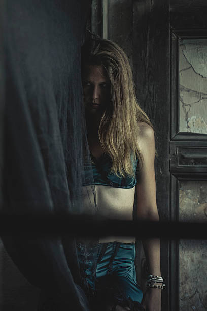 istock Sad young woman standing between doorframe 171321807