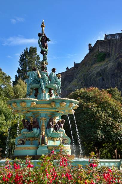 Ross Fountain in Edinburgh Princess Street Gardens in the October sun, with pink flowers at the front. Fountain was installed in 1872, restored in 2018, example of cast- iron structure  , one of the most popular places in Edinburgh