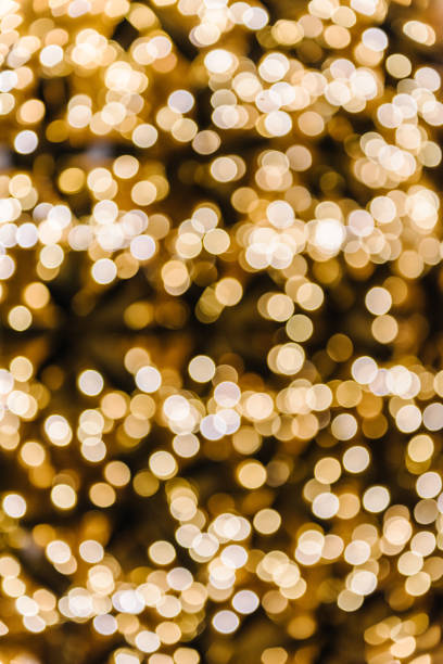 istock Yellow abstract blur bokeh made from Christmas light on black isolated background. Bokeh lights. Greeting card. Happy New Year 2024. Beautiful holiday billboard or festive glowing golden wall. Closeup 1713221070