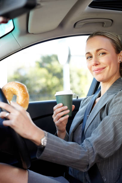 istock Female Executive Holding Bagel And Coffee Cup 171322323