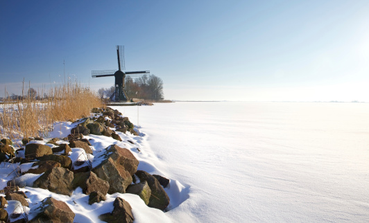 Windmill in a Dutch winter scene, near Oudega (Friesland, the Netherlands)