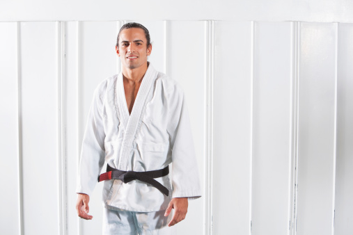 Jiu-Jitsu instructor - Hispanic man (20s).  Brazilian jiu-jitsu is a martial art, self defense system and combat sport.