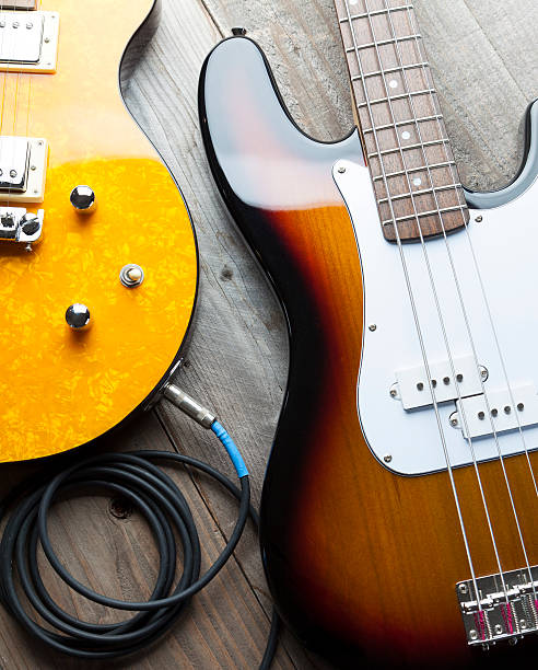Two Guitars Bass and lead electric guitars on old wood bass guitar stock pictures, royalty-free photos & images