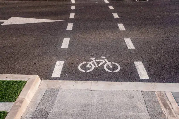 New bike lanes next to recharging stations for electric vehicles on paved asphalt.