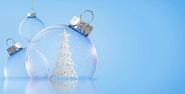 istock Christmas transparent balls with a Christmas tree inside on a blue background. Christmas background. 1713230502