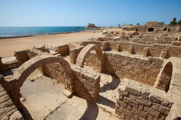 The ancient port and arena with Roman Ruins along the Mediterranean Sea at Caesarea Maritima National Park in Caesarea, Israel. Caesarea is a town on Israel's Mediterranean coast. It’s known for Caesarea National Park, which includes a large Roman amphitheater and the historic port.