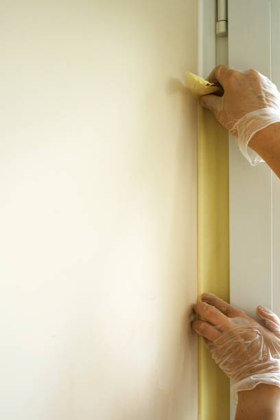 istock worker applying masking tape before painting walls 1713232107