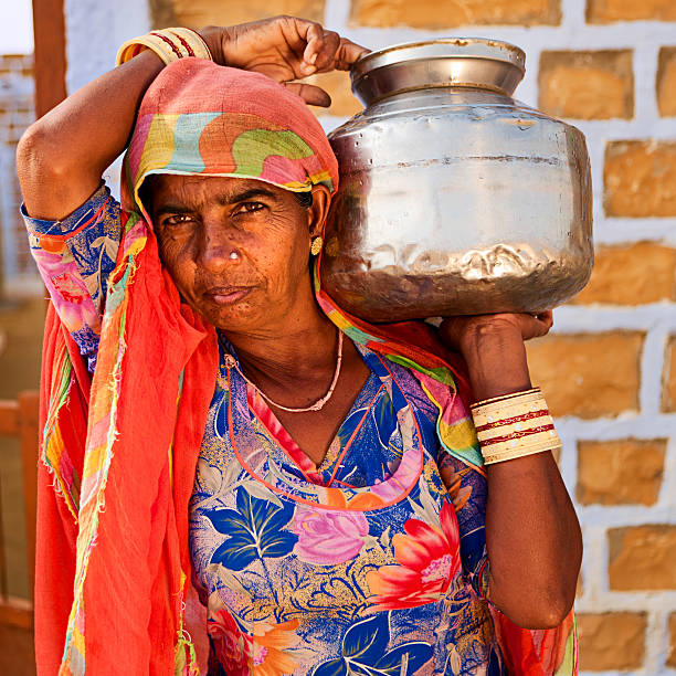istock Indian woman carrying water from well 171323639