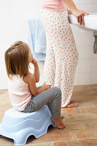 istock Daughter Reluctant To Brush Teeth With Mother 171324452