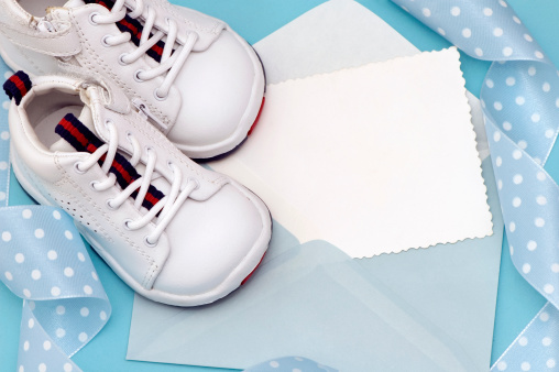 Baby Shoes with Blue Ribbon on white Background.See more: