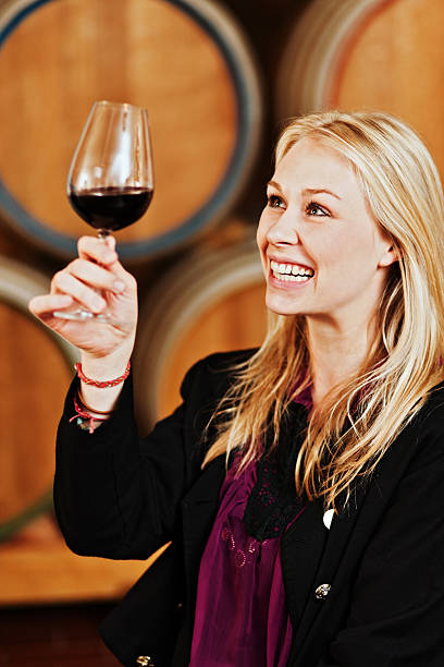 istock Beautiful, smiling blonde winestasting in winery cellar 171324826