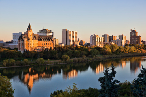 Horizontal image of early morning skyline and South Saskatchewan River in Saskatoon.