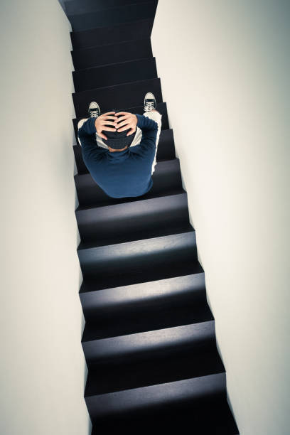 istock Depressed man sitting on the stairs 171325192