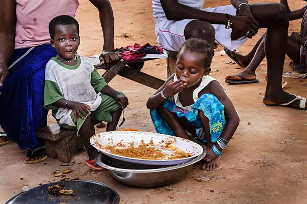 "Two African children eating rice in Ziguinchor's house, Senegal"