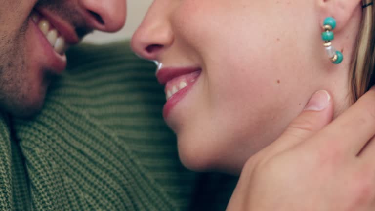 Couple, love and touch on face at home with happiness, care and support in a healthy marriage. A happy man and woman together with affection while talking, bonding time or relax with comfort or smile