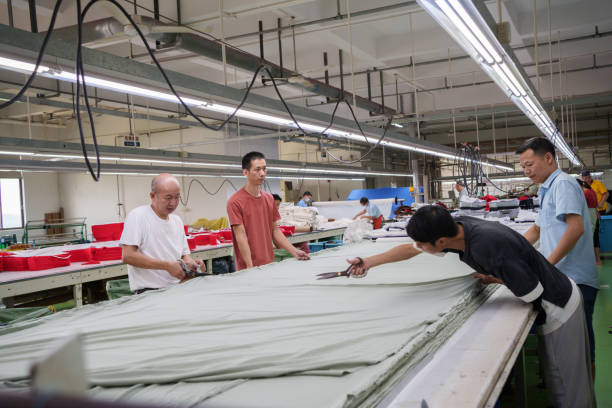 istock Cloth cutting worker in garment factory 1713259865