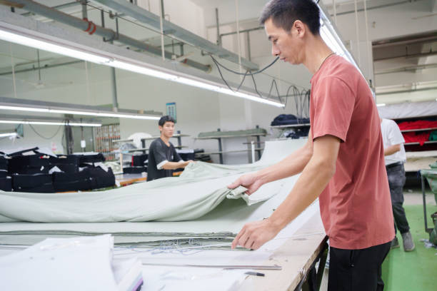 istock Cloth cutting worker in garment factory 1713260060