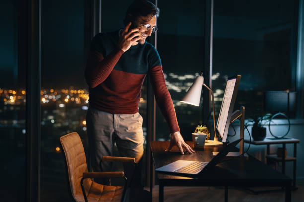 istock Professional discussing project late at night in office 1713261671