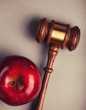 Legal education concept with a gavel and apple.
