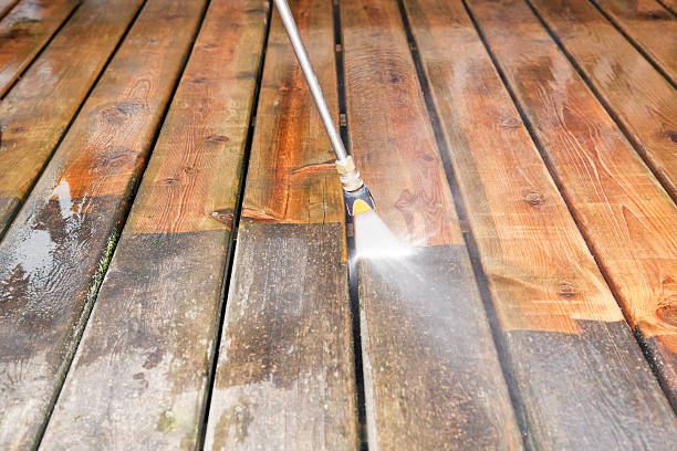 Pressure Washer Cleaning a Weathered Deck A pressure washer sprayer is cleaning a weathered treated wood deck. The background wood has been cleaned, the lower portion is dirty and weathered, showing the contrast. Focus is on the wood, the nozzle is slightly soft. cleaning wood stock pictures, royalty-free photos & images