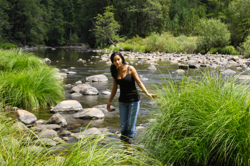 Beautiful young latina woman and mountain river.