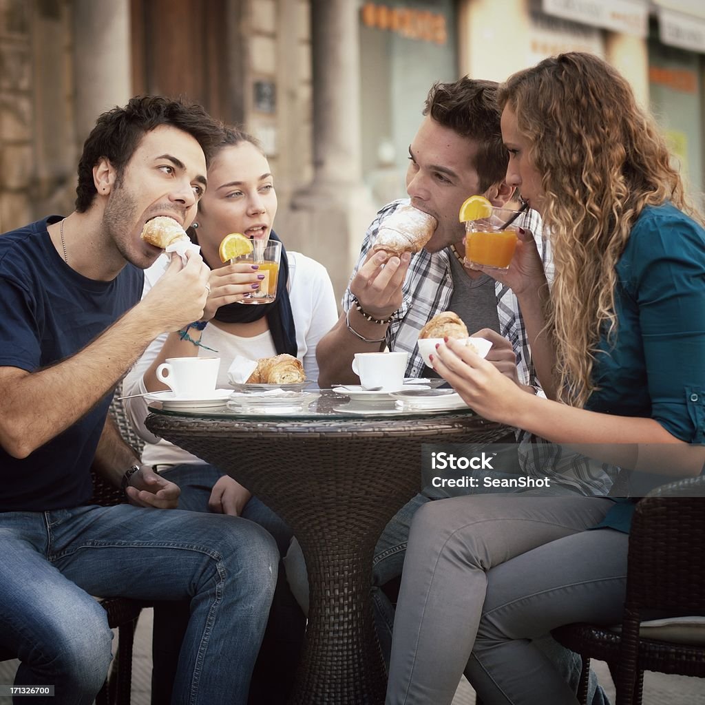 Quatre amis profiter d'un petit déjeuner au Café. - Photo de Croissant - Viennoiserie libre de droits